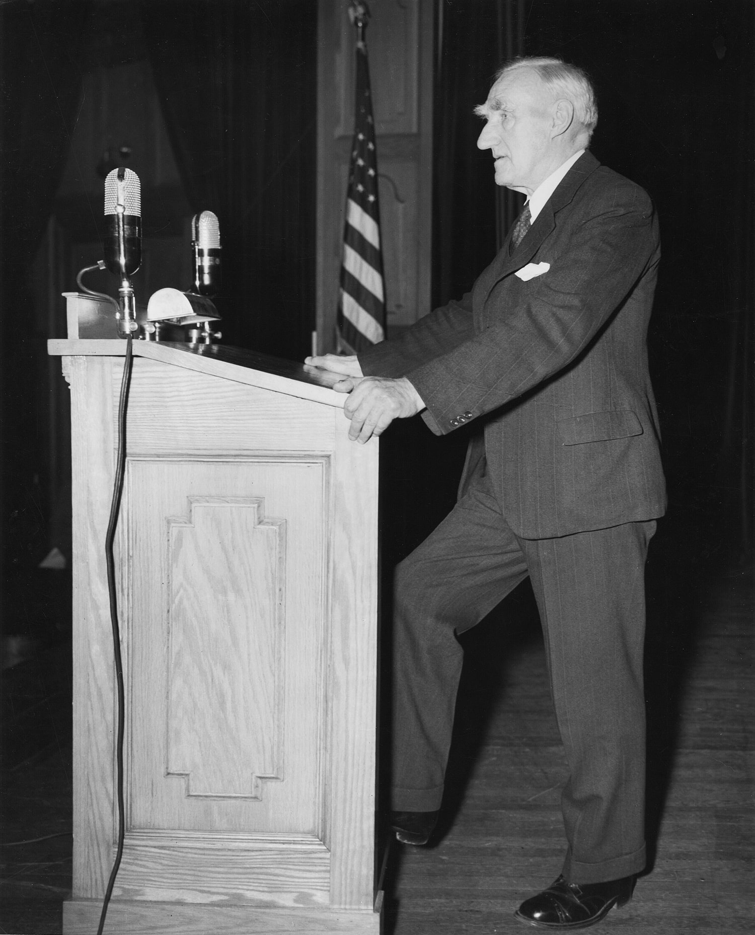Signing ceremony against a backdrop of national flags