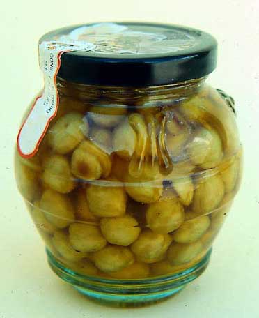 Hazel nuts packed in liquid honey.