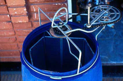 View of top of extractor with basket modified for six shallow super frames or 2 deep super frames. Ideally, the gear and chain assemblage  should have a plate below it to protect the honey from oil or other debris. The whole assembly can be easily removed for cleaning or use of the drum for storage.